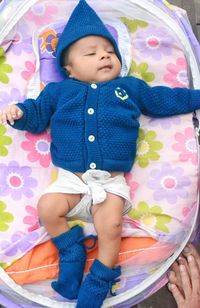 High angle view of baby girl on bed