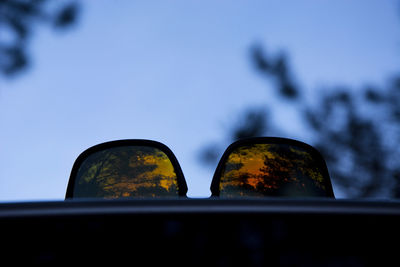 Close-up of shoes against sky