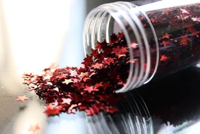 Close-up of red glittering stars on table