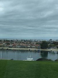 Scenic view of lake against sky in city