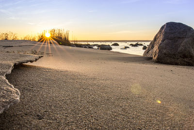 Scenic view of beach against sky during sunset