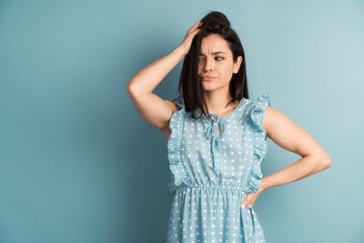 Portrait of a beautiful young woman against gray background