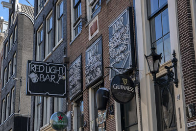 Low angle view of road sign on building