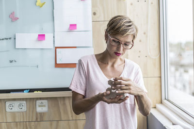 Woman working on wooden building blocks in modern office