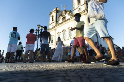 People on street against buildings