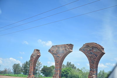 Low angle view of arch bridge against sky