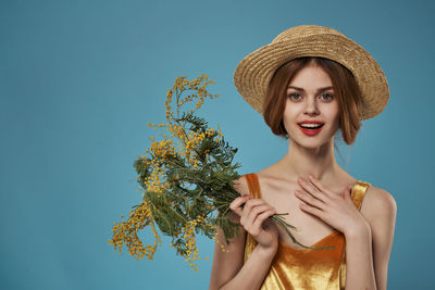 Portrait of beautiful young woman against white background