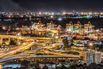 High angle view of illuminated cityscape against sky at night