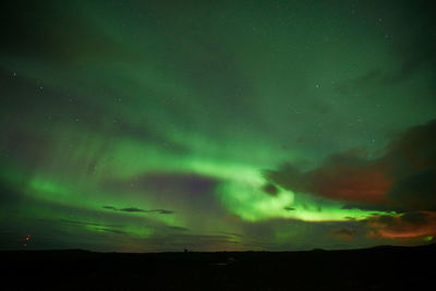 Scenic view of landscape against sky at night