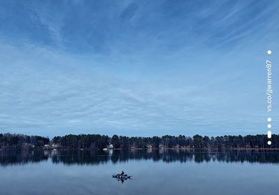 Scenic view of lake against sky at dusk