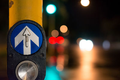 Close-up of road sign at night