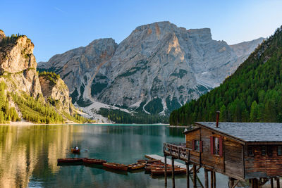 Scenic view of lake and mountains against clear sky