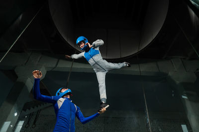 Rear view of man skateboarding on ceiling