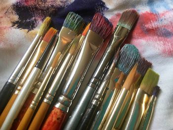 Close-up of paintbrushes on textile