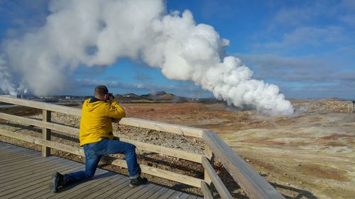 Full length of man standing on mountain against sky