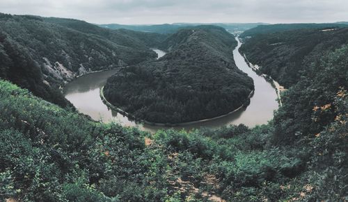 Panoramic view of river amidst mountains against sky