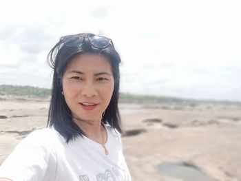 Portrait of smiling young woman on beach