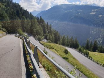 Panoramic view of road by mountains against sky