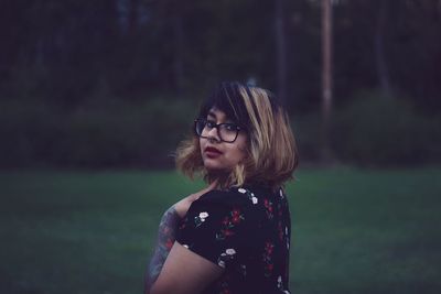 Portrait of beautiful woman standing on land