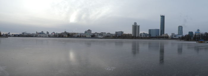 Panoramic view of city buildings against sky