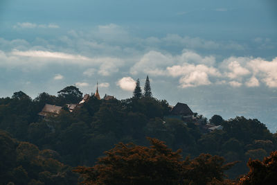 Panoramic view of trees and buildings against sky