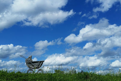 Grass on field against blue sky