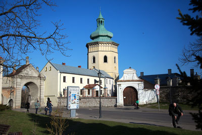 People in front of church against blue sky