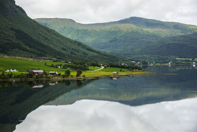 Scenic view of lake and mountains against sky