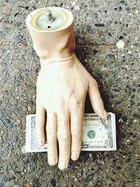 Cropped hand of woman holding paper currency