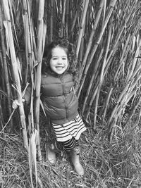 Portrait of young woman standing in forest