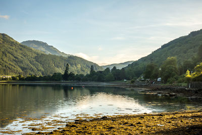 Scenic view of lake and mountains against sky