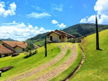 Scenic view of landscape and houses against sky