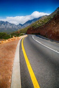 Surface level of empty road against mountain range