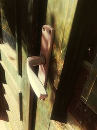 Close-up of open window on wooden door