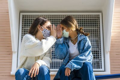 Women sitting in front of woman