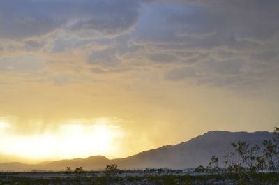 Scenic view of silhouette mountains against sky during sunset