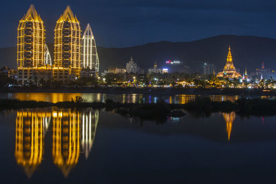 Reflection of illuminated buildings in city at night