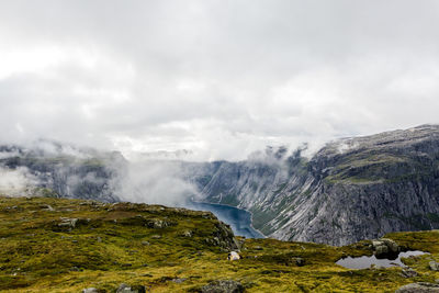 Scenic view of waterfall against sky