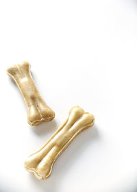 Directly above shot of dog bone shape candies against white background