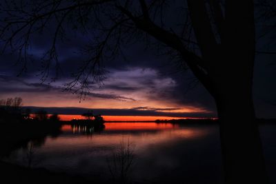 Scenic view of lake against sky at sunset