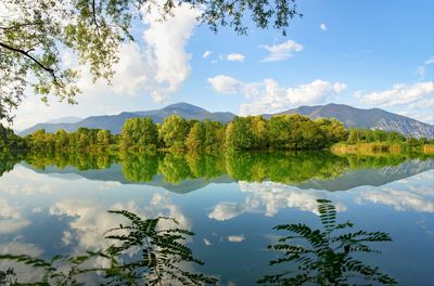 Scenic view of lake and mountains against sky