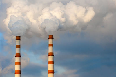 Low angle view of smoke stack against sky