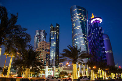 Low angle view of illuminated buildings at night. west bay doha, qatar
