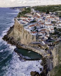 High angle view of buildings by sea