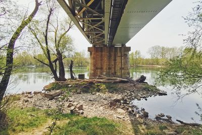 Arch bridge over river against sky