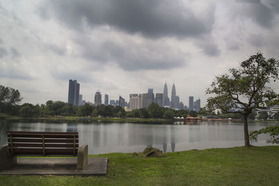 Scenic view of river by buildings against sky