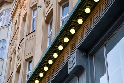 Low angle view of illuminated lights on building in city