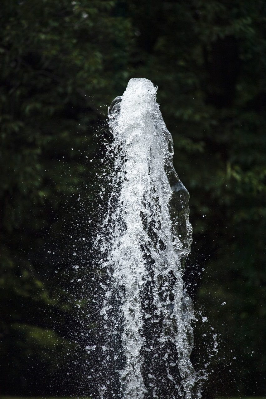 CLOSE-UP OF WATER SPLASHING ON ROCKS