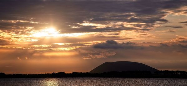 Scenic view of silhouette mountains against sky during sunset