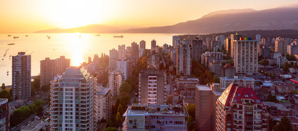 Cityscape against sky during sunset